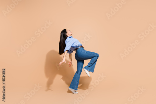 Canvas-taulu Young woman showcasing casual modern fashion in stylish denim and shirt against