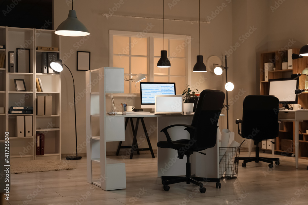 Interior of programmer's office with desks and glowing lamps Interior of programmer's office with desks and glowing lamps