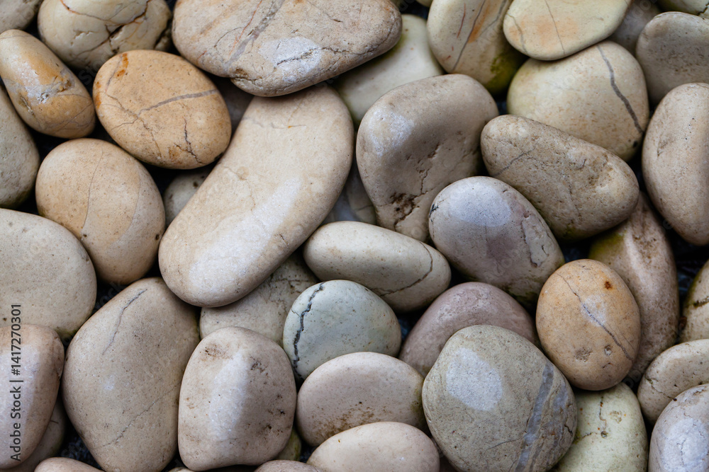 Small and medium sized white natural stones, commonly used for garden decoration. Natural stone texture and background for graphic design.