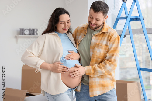 Young pregnant couple touch...