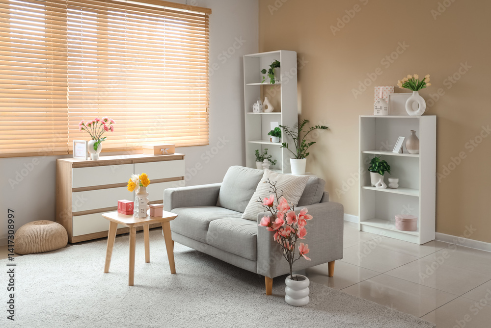 Interior of living room decorated for Mother's Day with sofa, table and shelf units