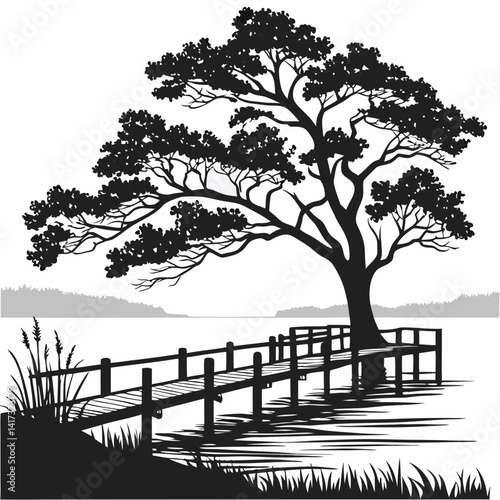 A lone tree stands in silhouette on the sandy beach where the sea meets the shore under the vast sky
