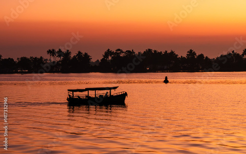 silhouette of boat in Alappuzha, highly visited tourist destination, during the sunset
