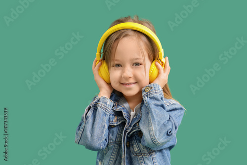 Cute little girl in headpho...