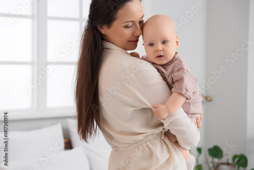 Happy mother hugging her li...