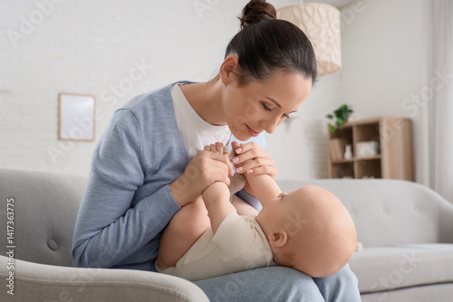 Mother holding her little b...
