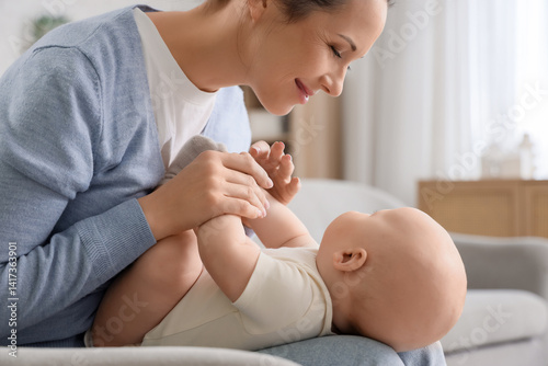 Mother holding her little b...