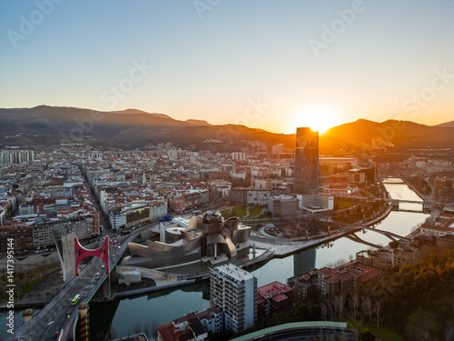 Bilbao cityscape with Guggenheim Museum, Nervión river and Iberdrola tower at sunset