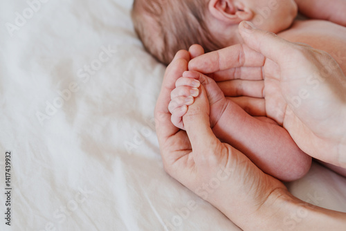 Close-up little hand of child baby holding hand of mother.