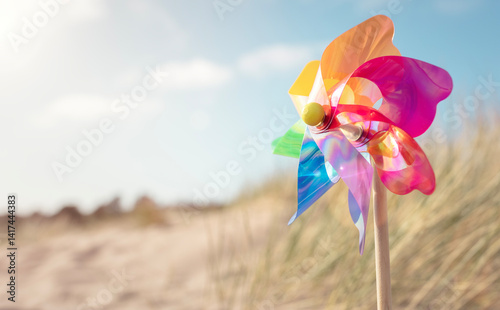 Summer beach background, pinwheel or windmill in the sand