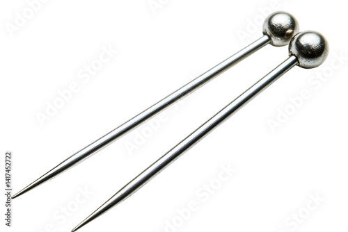 Pair of shiny silver hat pins with spherical heads on white.