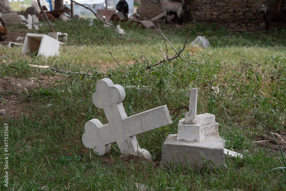Fallen cross lying on grass symbolizing loss and grief