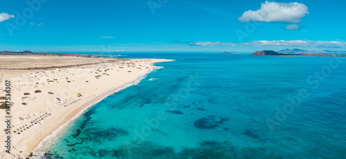 Fototapeta Naklejka Na Ścianę i Meble -  High quality aerial panoramic image of the beautiful Flag Beach, Grandes Playas with Lobos island in the background near Corralejo in Fuerteventura Spain