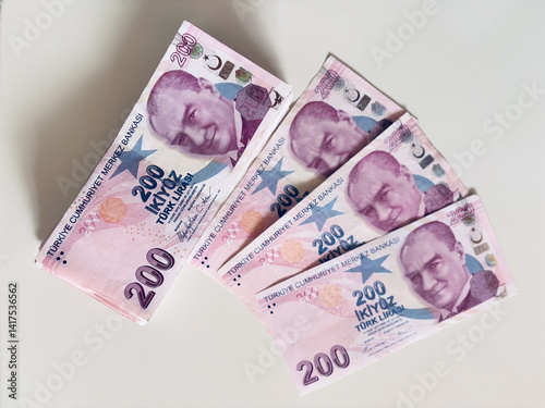 Fototapeta Naklejka Na Ścianę i Meble -  Turkish 200 Lira banknotes arranged on white background, emphasizing wealth and currency exchange