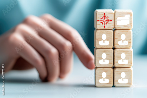 Obraz na płótnie Building tower of wooden cubes, professional hand carefully stacks blocks featuring icons representing users and target symbol, symbolizing focus and organization in business w salonie