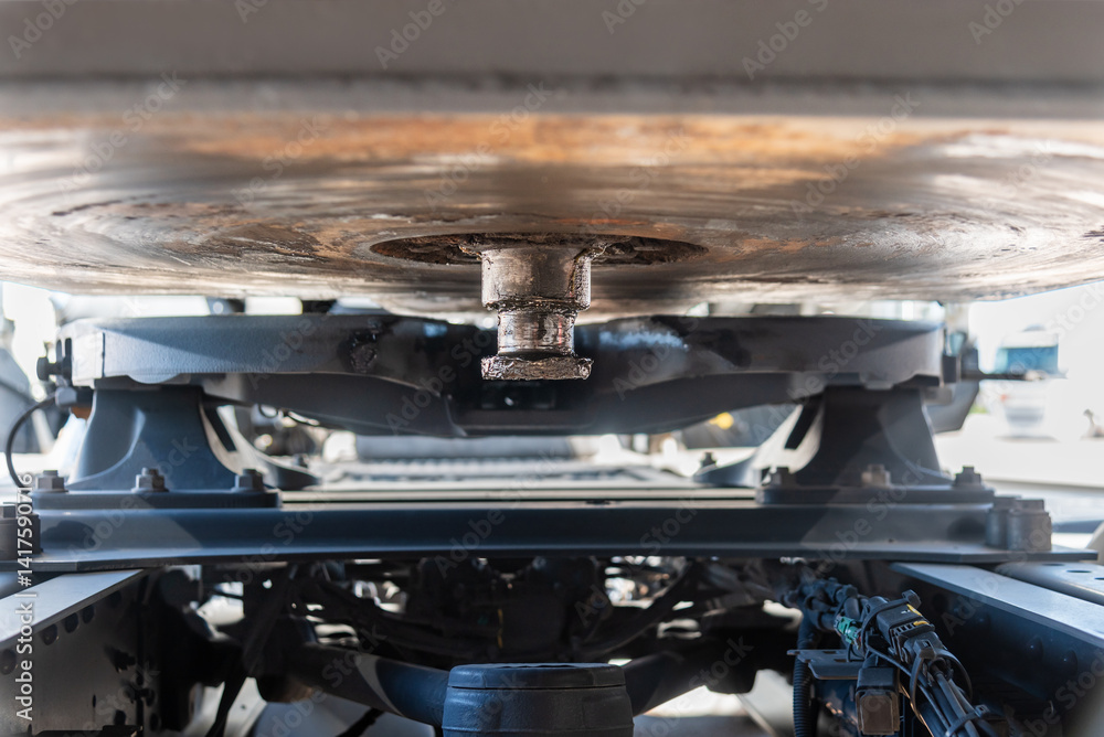 Close-up of a trailer kingpin and fifth wheel coupling