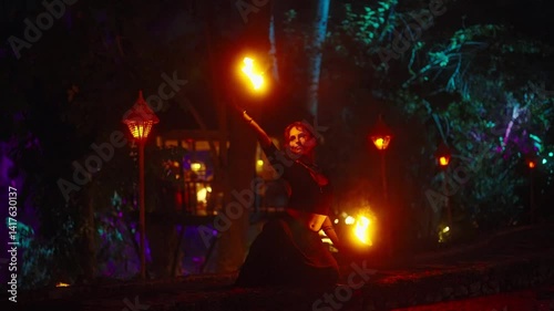 Show of dancing with fires, performance using burning torches in night.