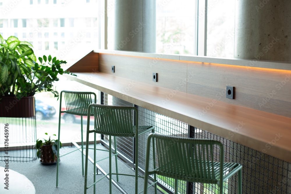 Fototapeta premium Modern cafe interior with window counter seating and minimalist design