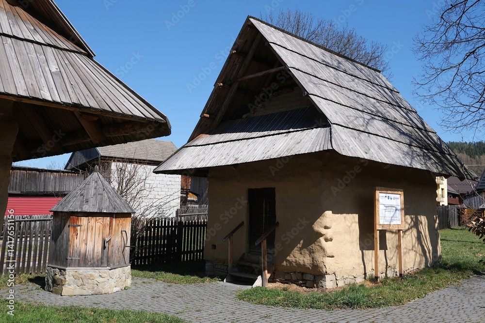 Hiscoric buildings named sypaniec in Kacwin, Poland. These are original Spis granaries - wooden grain warehouses, stone foundation covered with clay with movable sloping roof.