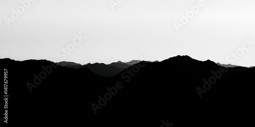 Grungy halftone mountain range silhouette, black textured landscape with fading grainy hills , rock, empty space
