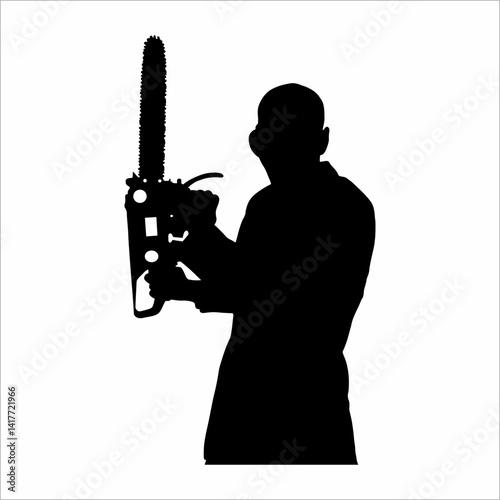silhouette of a man holding a chainsaw