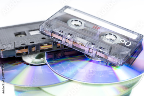 Retro Sounds of Time: A nostalgic collection of audio cassette tapes and compact discs, a vivid reminder of musical evolution.