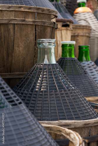 Traditional glass wine bottles with protective wicker baskets preserving wine heritage