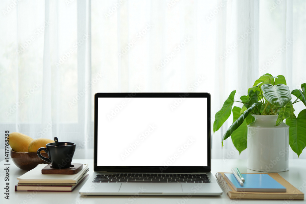Laptop white screen and drink and mango, cozy indoor work space Laptop white screen and drink and mango, cozy indoor work space