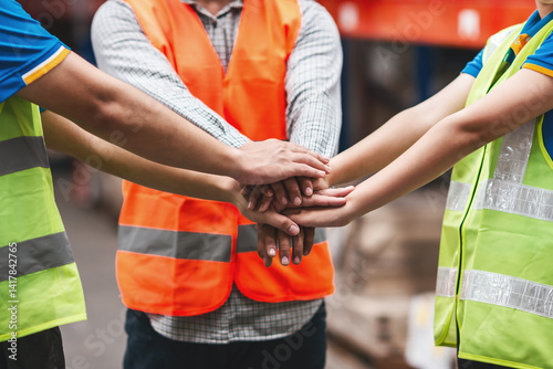 asian warehouse team worker showing spirit. logistic shipping worker with safety helmet and vest gesture. female and male team work employee group showing team spirit workplace for effectively work