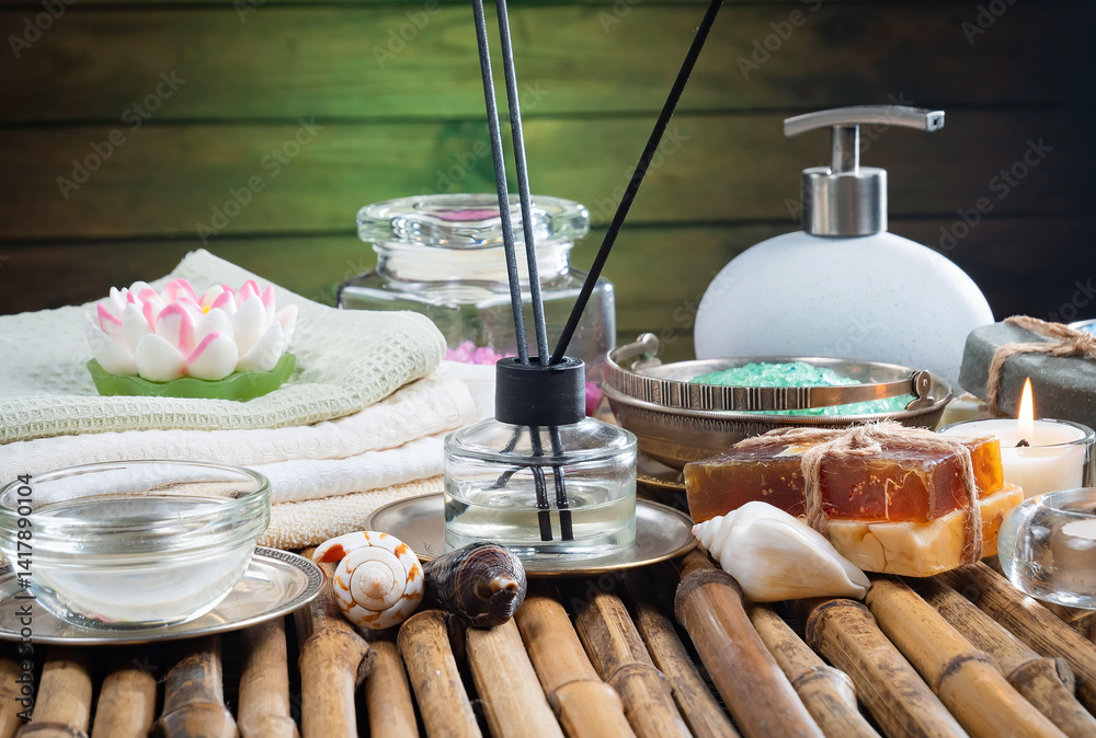 Spa treatment with candles and towel on wooden table, closeup