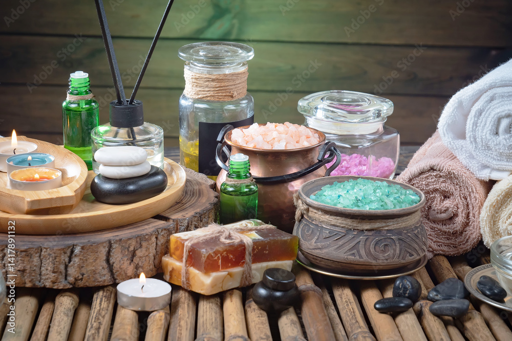 Spa treatment with candles and towel on wooden table, closeup