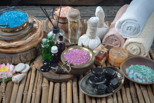 Spa treatment with candles and towel on wooden table, closeup
