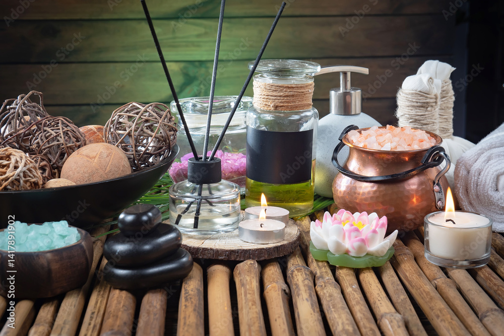Spa treatment with candles and towel on wooden table, closeup