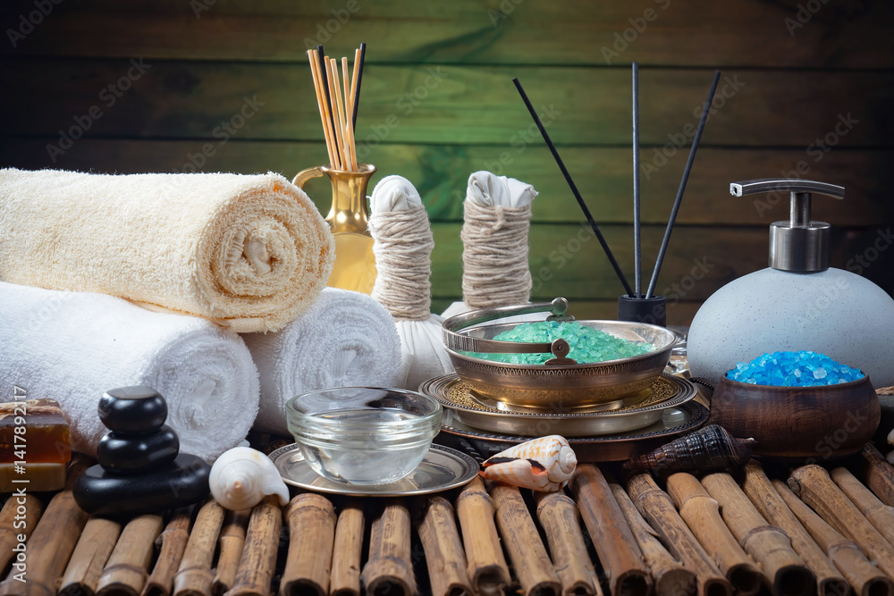 Spa treatment with candles and towel on wooden table, closeup