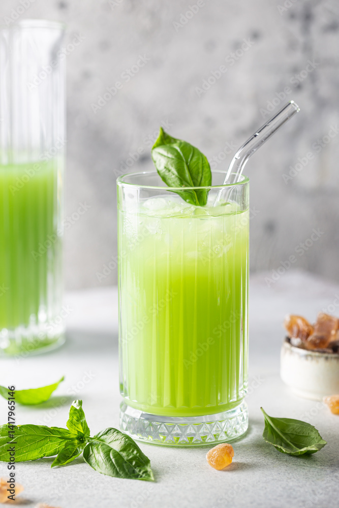 Cold basil lemonade refreshing summer drink on gray background