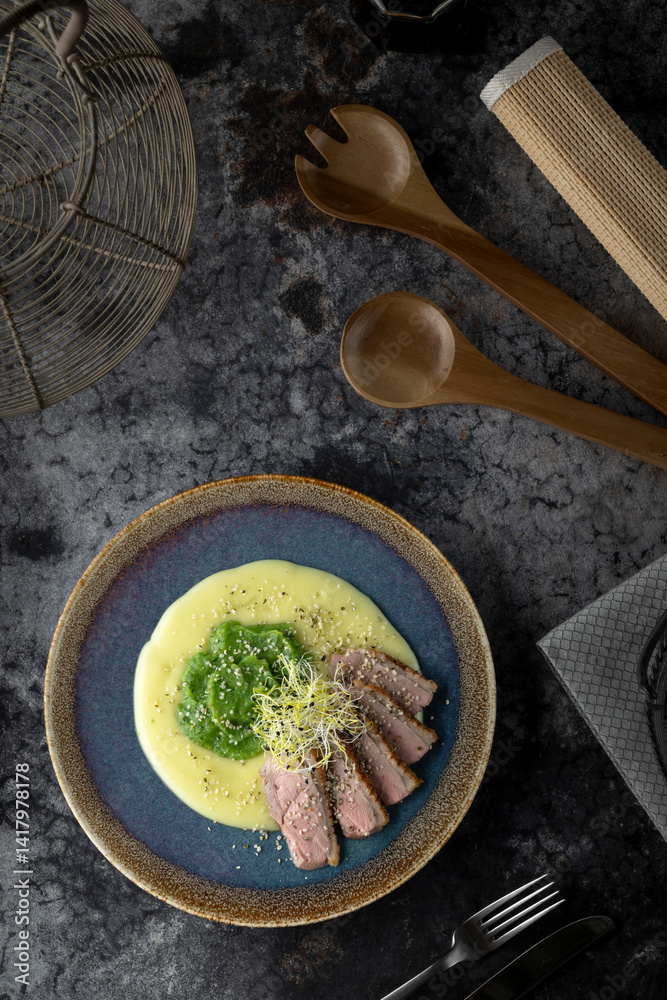 Delicious duck breast with creamy mashed potatoes, green peas puree and sesame seeds, healthy and tasty recipe