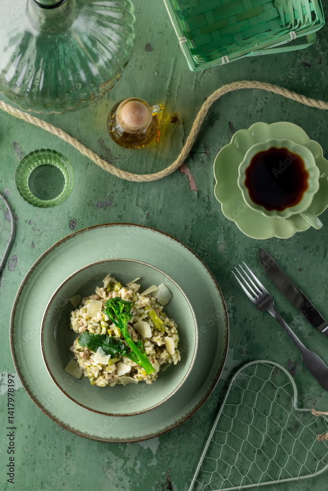 Delicious green risotto with broccoli and asparagus decorating table setting