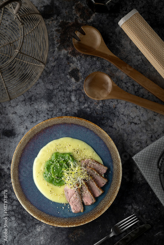 Delicious duck breast with creamy mashed potatoes, green peas puree and sesame seeds, healthy and tasty recipe