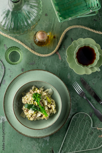 Obraz na płótnie Delicious green risotto with broccoli and asparagus decorating table setting w salonie