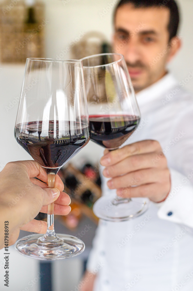 Glass of red wine in hands. Selective focus. Glass of red wine in hands. Selective focus.