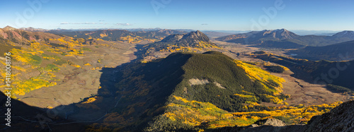 Mt Crested Butte (12,162') standing as an island in the Elk Range mountains of Colorado.  Adorned by colorful vibrant aspen trees on this beautiful autumn afternoon.