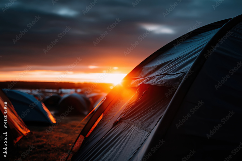 Fototapeta premium Sunset view of tents during a camping event in the mountains on a summer evening