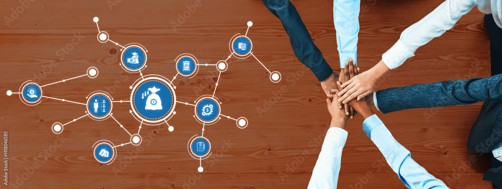 Aerial view of hands joining together on a wooden table, symbolizing teamwork and collaboration in business. Digital icons around represent innovative ideas and strategies. Amity