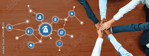 Obraz na płótnie Aerial view of hands joining together on a wooden table, symbolizing teamwork and collaboration in business. Digital icons around represent innovative ideas and strategies. Amity w salonie