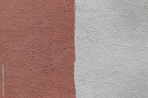 A wall with a red and white stripe. The red is darker than the white. The wall is made of concrete.