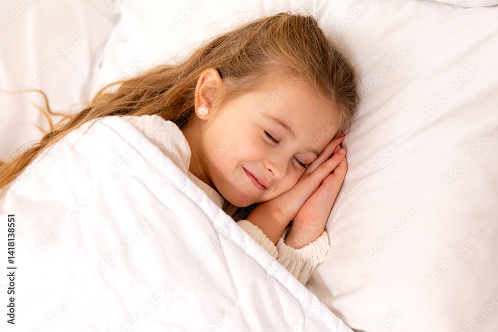 Cute little girl sleeping in bed. Little blonde girl sleeps sweetly in bed with white linen. space for text. healthy baby's sleep. High quality photo