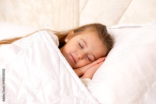 Cute little girl sleeping in bed. Little blonde girl sleeps sweetly in bed with white linen. space for text. healthy baby's sleep. High quality photo