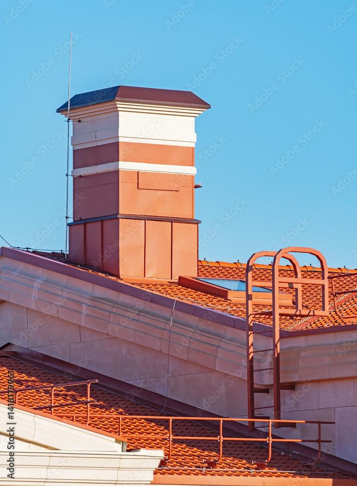 house with a roof from a red shingles with a pipe