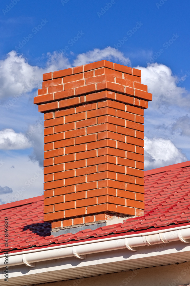 house with a roof from a red shingles with a pipe