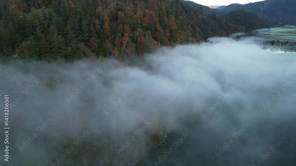 Fog Rolls Over Autumn Forest and Lake in British Columbia, Canada Fog Rolls Over Autumn Forest and Lake in British Columbia, Canada